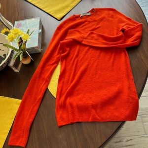 Bright orange-red long sleeve.
